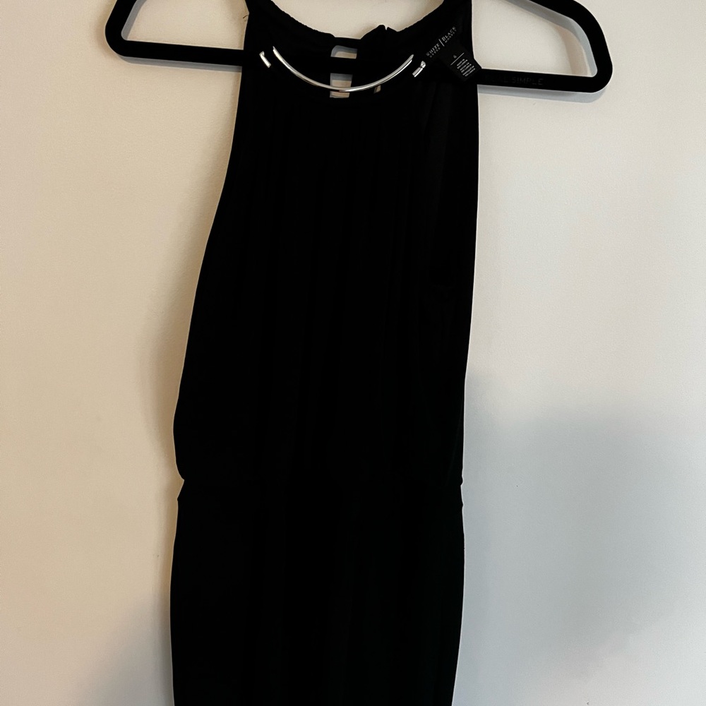 Black jumpsuit with a silver necklace detail very flattering shape